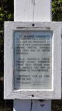 Croix de chemin. Affiche apposée sur la croix de chemin