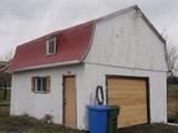 60, 3e Rang Est (avec garages). Garage 1. Vue avant
