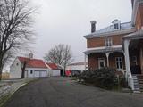 Site patrimonial de La Présentation-de-la-Sainte-Vierge. Garage, remise et grange derrière le presbytère